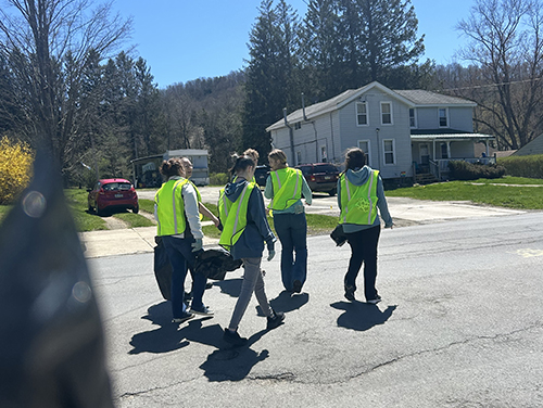 Group of four students walking through a neighborshood