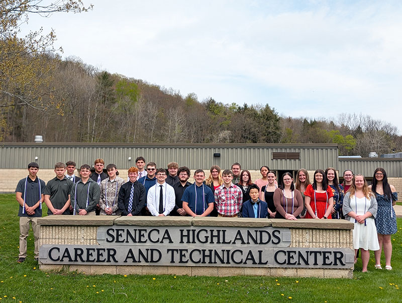 Seneca Highlands Career and Technical Center National Technical Honor Society Induction Ceremony members outside next to school sign