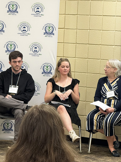 Students sitting in a panel to share experiences