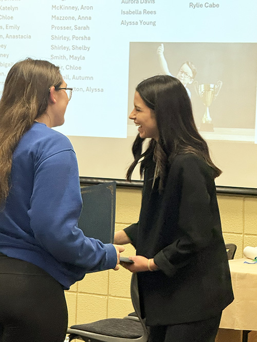 Two women greeting each other