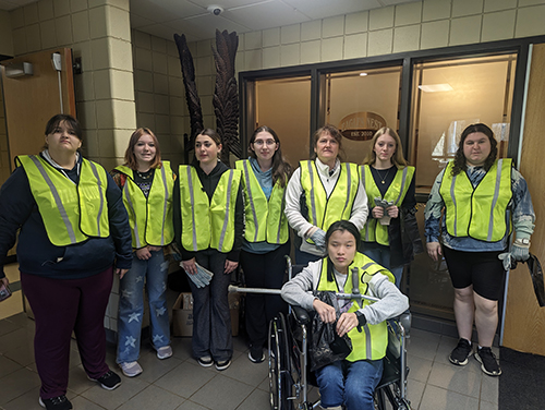 Group of students ready to help the community in yellow safety vests