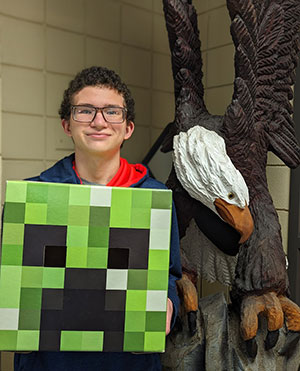 Nathan Haight holding a Minecraft monster head