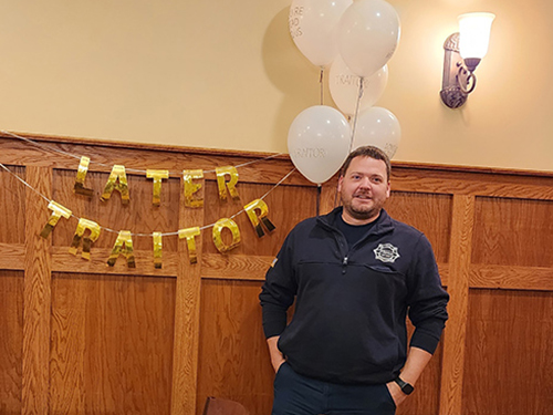 Mr. Johnson next to balloons