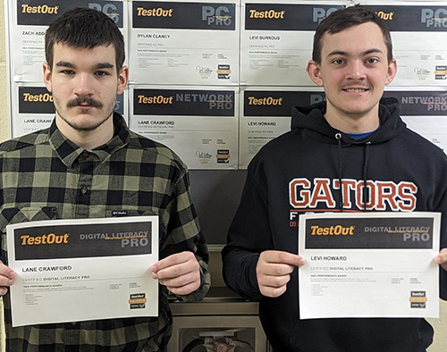 Lane and Levi proudly holding up their certificates