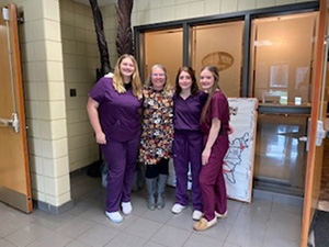 Students Jade Williams, Rylie Collins, and Patience Dunkle with their instructor, Mrs. Lana Barth
