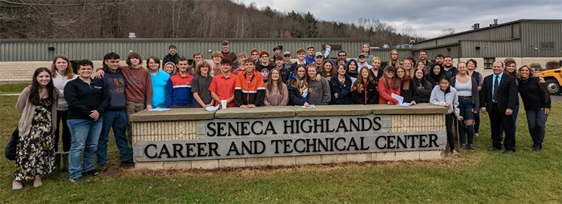 Students and teachers participating in SkillsUSA posing for a picture next to the Seneca Highlands CTC campus sign