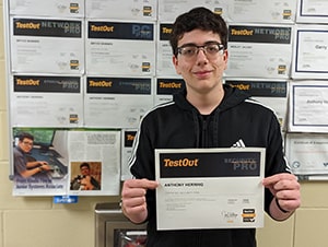 Anthony Herring holding up certificate