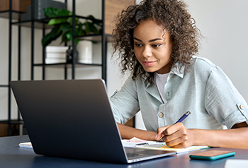 Young lady searching for scholarships on her laptop