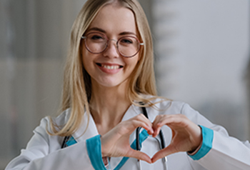 Young medical assistant making a heart with her hands