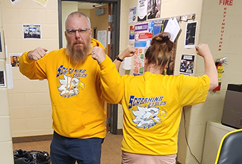 Two Screaming Eagles members wearing yellow team t-shirts